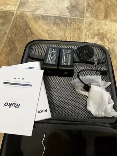 Ruko U11 mini drone kit in hard case with mesh lid, batteries, charger, and cable