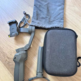 Grey drone carry case with zipper and folded drone parts