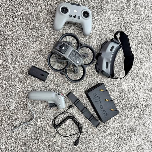 FPV drone controller kit with goggles, battery pack, cables, and prop guards