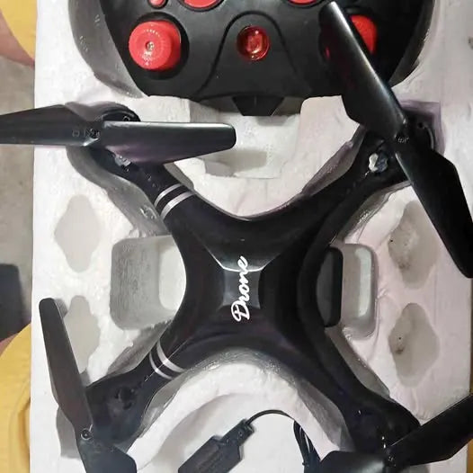 Black quadcopter drone with four propellers and camera mount detail