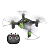 Pocket RC quadcopter drone with green accents and white prop guards, plus black remote controller