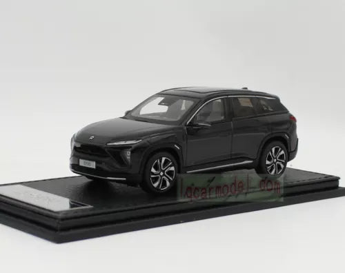 Black metal diecast car model, front 3/4 view with detailed wheels
