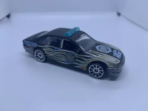 Used 1:64 diecast police car with dark blue body and flame graphics, blue light bar