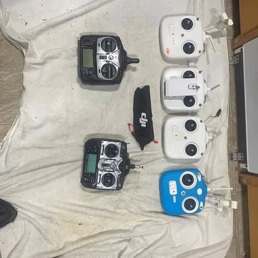 Assorted DJI drone remote control parts with handheld transmitters and blue controller