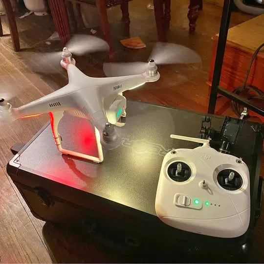 White quadcopter drone with front camera and four rotors