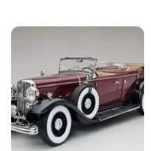 Maroon vintage diecast car with chrome details in display packaging