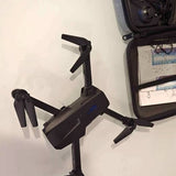 Black quadcopter drone with four propellers and foldable arms