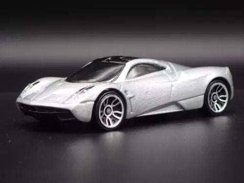 Silver 1:64 scale diecast supercar model, front-side view