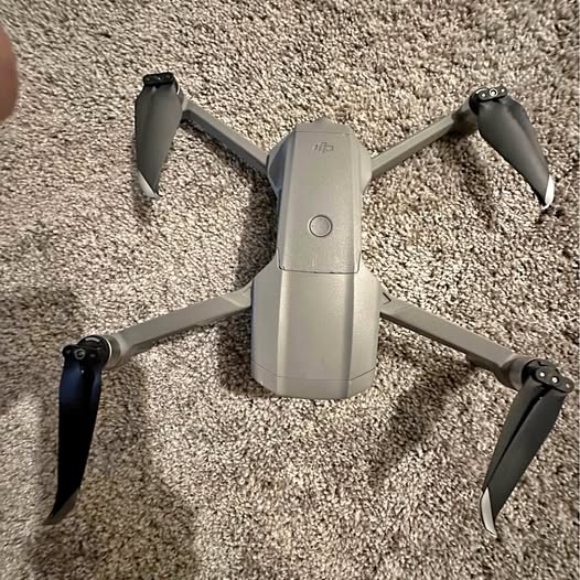 DJI Mavic Air 2 drone with four propellers, gray body and gimbal