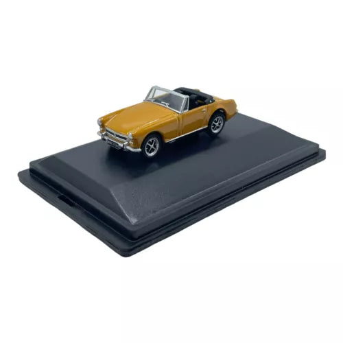 Yellow MG Midget diecast model car with black interior, front three-quarter view on base