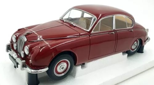 Maroon classic diecast car model with chrome grille and whitewall tires, side view.
