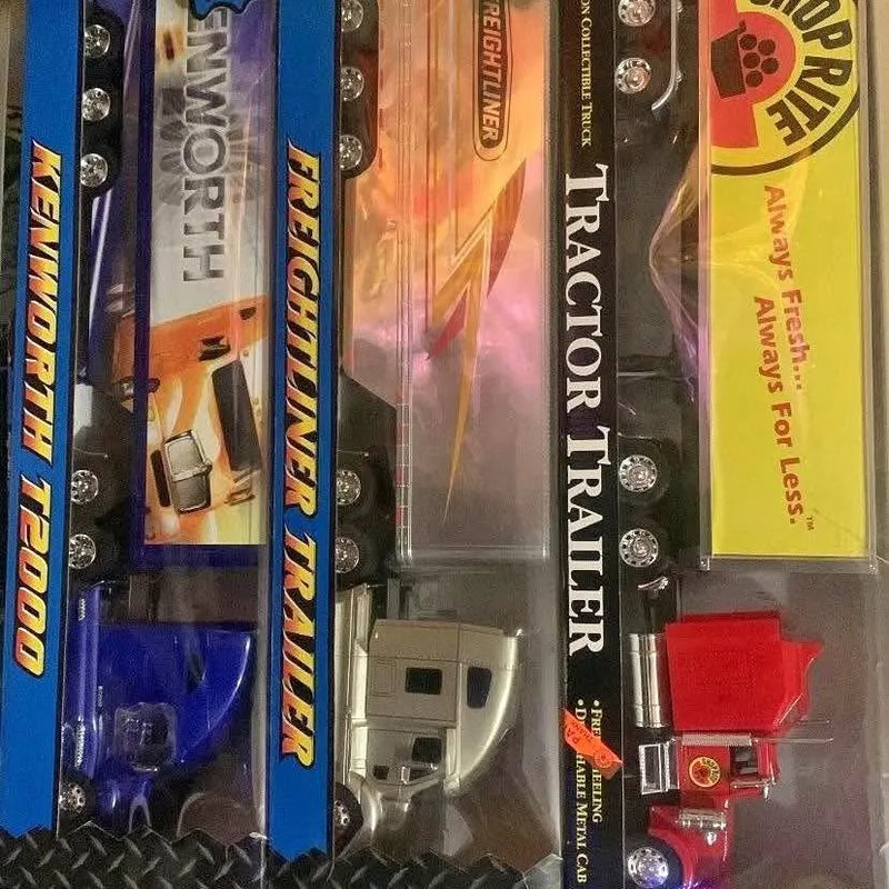 Diecast truck toys in blister packaging, with blue, silver, and red trucks visible