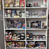 NASCAR diecast cars and collectible boxes on a retail display shelf
