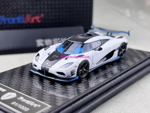 White sports race diecast model car with black hood and blue accents on display base