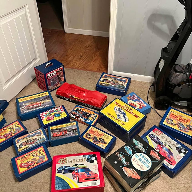 Vintage diecast car collection with boxed sets and a red car model
