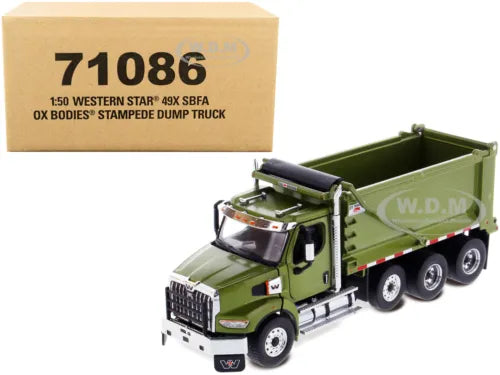 Green die-cast dump truck model with open tipping bed and detailed cab