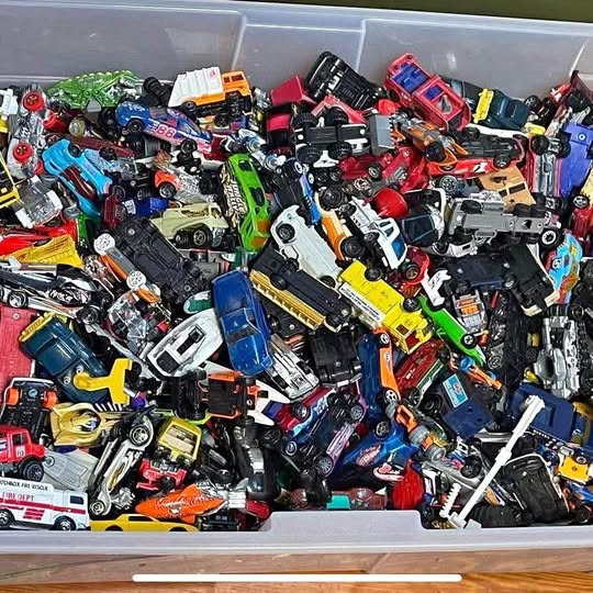 Assorted diecast car lot with many miniature vehicles in a storage tray