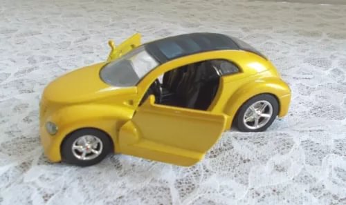 Yellow diecast toy car, doors open, 1:32 scale with chrome wheels