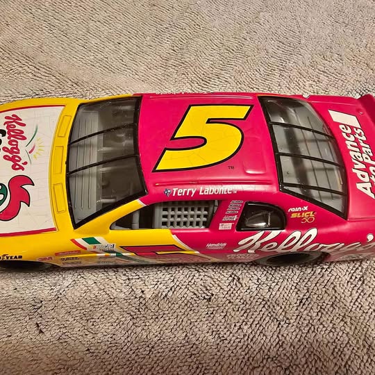 Diecast NASCAR race car with red and yellow body, large #5 on hood