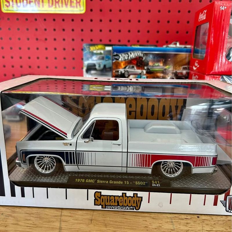 White diecast pickup truck with red racing stripe and detailed chrome wheels