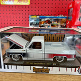 White diecast pickup truck with red racing stripe and detailed chrome wheels