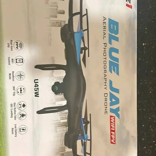 Black RC drone with dual wings and landing supports on retail packaging