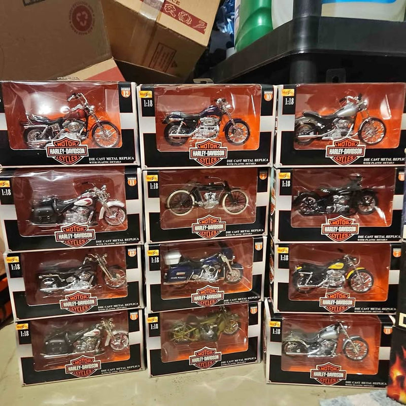 Assorted diecast collectible motorcycles in retail boxes