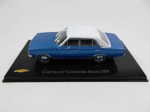 Blue diecast sedan model car with white roof on black display base