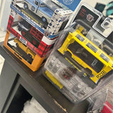 Diecast car model in blister pack, yellow and dark gray, M2 styling