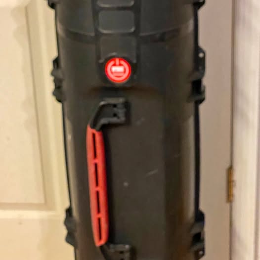 Hard plastic tube case with red latch and handle