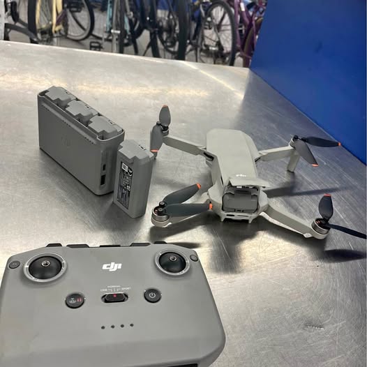 DJI Mini 2 drone controller with folding arms and propellers, grey
