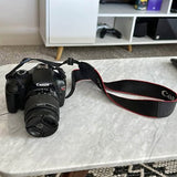 Canon EOS Rebel T3 DSLR camera with black lens and neck strap