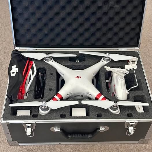 White DJI Phantom 3 standard drone with propellers inside a hard case