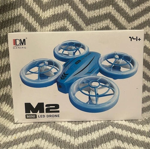 Mini LED drone box with blue four-propeller drone