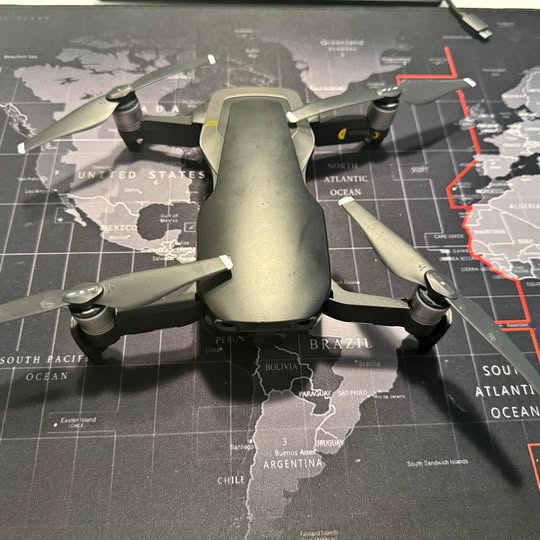 DJI Mavic Air drone with four propellers, centered view, dark gray body