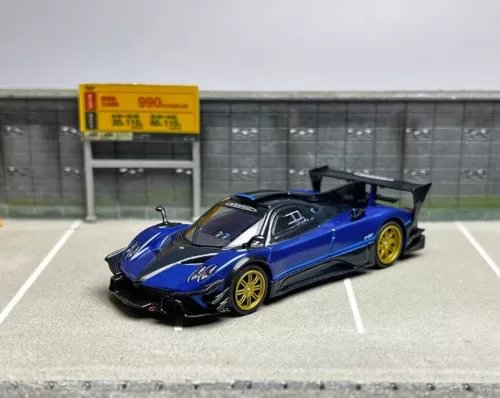Blue and black racing diecast model car, open doors, 1:64 scale.