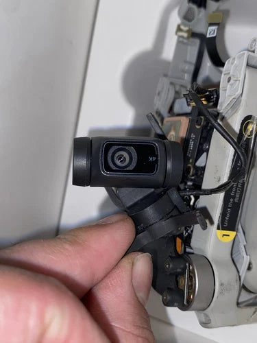 Compact quadcopter drone with front camera and gimbal, shown close-up