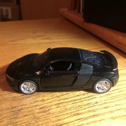 Black 1/32 diecast sports car toy with chrome wheels, side view