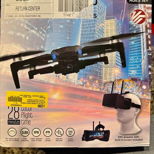 Racing drone with camera and FPV goggles on product packaging