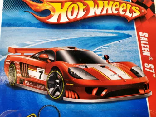 Red and black diecast race car with Hot Wheels logo on card packaging