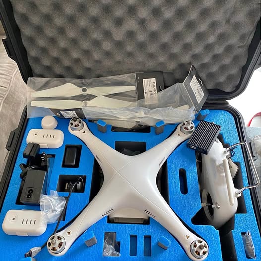White DJI Phantom 2 drone with propellers, inside protective hard case