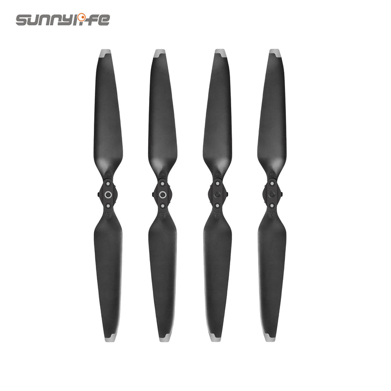 Four dark gray drone propellers with mounting hubs