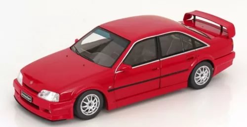Red diecast sedan model with detailed wheels and doors, front three-quarter view