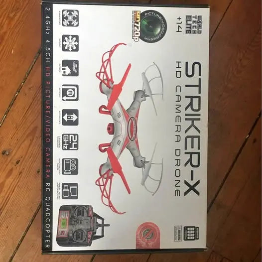 Drone in retail box, red and gray quadcopter with controller and app icons