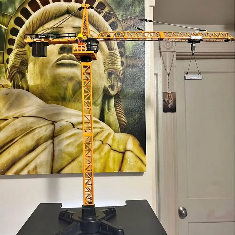 Yellow lattice tower crane model with long boom on black base