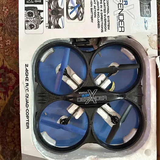 Quadcopter drone frame with blue prop guards and four propellers