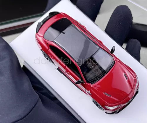 1:64 scale red sports car diecast model with black accents