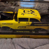 Yellow and black diecast 1957 Chevy 210 car model with Accel decals, front view