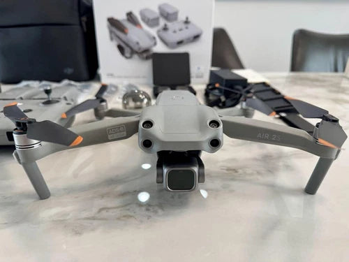 Gray quadcopter drone with front camera module and four rotors