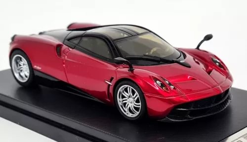 Red diecast supercar model with black windshield, front three-quarter view